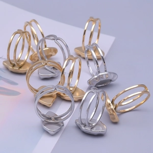 Detail of minimalist gold and silver double-layered rings with heart-shaped bases