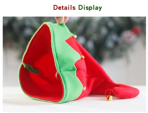 Close-up of red and green Christmas elf hat featuring small golden bells and soft fabric