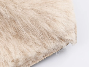 Macro view of light beige faux fur texture with soft plush fibers on this coat detail