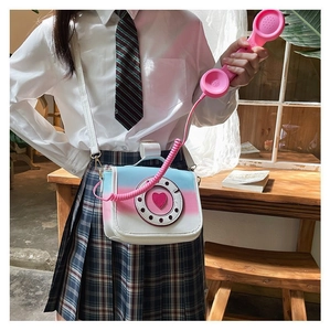 Detail view of quirky gradient PU leather telephone-shaped crossbody bag worn by model