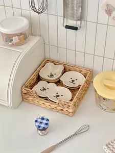 Cute cartoon bear ceramic dip dishes set inside a rustic woven basket for kitchen storage