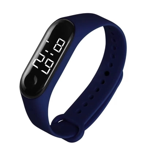 Close-up of blue LED digital watch with silicone strap and oval dial on white background