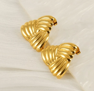Macro shot of 18k gold plated stainless steel earrings with layered wave texture