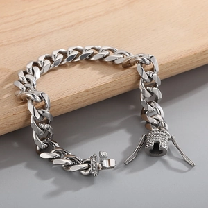 Detailed close-up of a silver Cuban link chain with a sparkling rhinestone-encrusted clasp