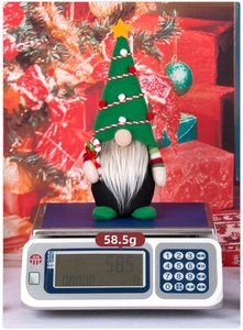 Detailed view of a Christmas gnome doll on a digital scale weighing 58.5 grams