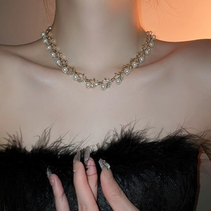 Elegant gold pearl necklace with crystal accents worn by a model for a luxury look