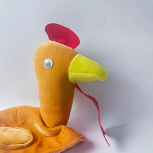 Detail view of the plush turkey hat with movable eyes and soft festive textures