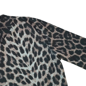 Detail of leopard print dress shoulder seam and lightweight fabric texture
