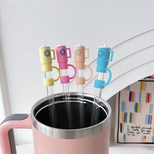 Silicone straw covers with daisy patterns on 10mm glass straws in a pink mug