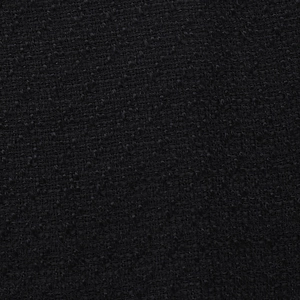 Macro shot of black tweed fabric texture showing intricate weave and elegant fiber details