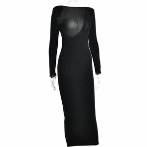 Close-up of black bodycon dress with shimmering metallic threads and long sleeves