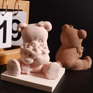Detail of 3D bear candle mold showing textured matte surface and rose head decoration
