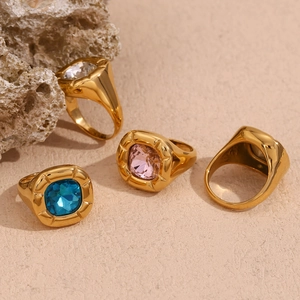 Macro detail of vintage 18K gold plated rings with colorful square zircon gemstones