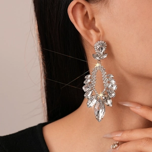 Luxurious silver tassel earrings with sparkling teardrop crystals on model