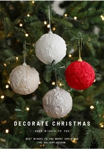 Close-up of 8cm fabric-wrapped Christmas ornaments with lace patterns on a lit Xmas tree