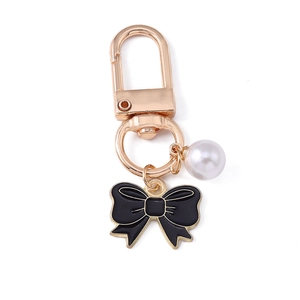 Elegant pearl and black bow keychain with gold metal clasp for bags and phone cases