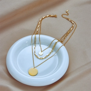 Three-layer gold titanium steel necklace with tiered chains and round pendant charms