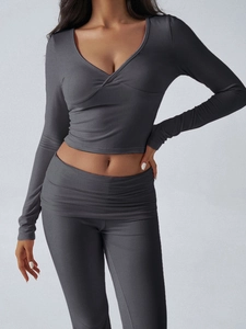 Detail view of dark grey slim fit knitted long sleeve top and wide leg pants set