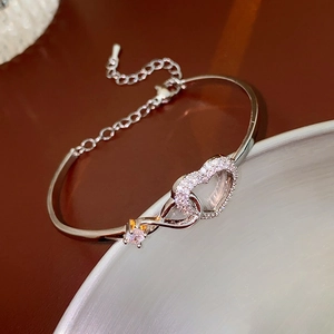 Detail of silver heart and infinity link bracelet with clear zircon stones and clasp