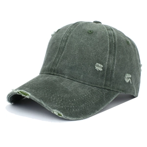 Detail of army green distressed cotton baseball cap with stylish ripped holes and stitching