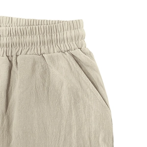 Detail of elastic drawstring waist and side pocket on khaki linen cargo shorts