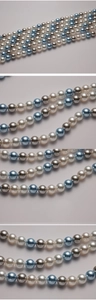 Detail of 8-12mm mixed white, silver and blue glass pearl beads for jewelry making