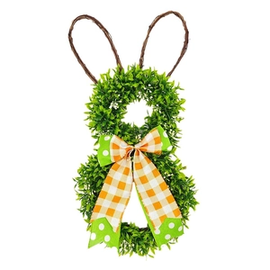 Detailed view of Easter bunny wreath with faux greenery, white buds and festive bow
