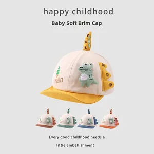 Detail of baby dinosaur cotton baseball caps with soft brims in five color combinations