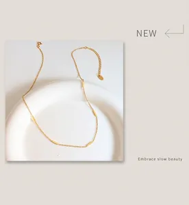 Close-up of gold-plated titanium steel necklace with five minimalist cuboid beads
