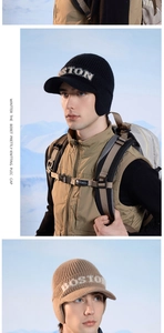 Detail of winter knit earflap hat with BOSTON lettering and short visor for men