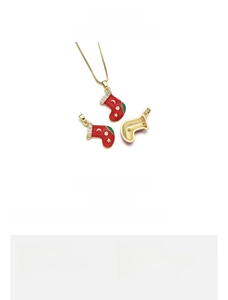 Detail of red enamel Christmas sock pendant in 18K gold-plated copper with star accents