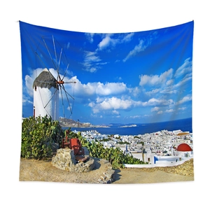 Detail of Santorini tapestry with white windmill and blue sea on a clean white wall