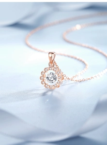 Detailed macro view of rose gold daisy pendant with central zircon and small crystals