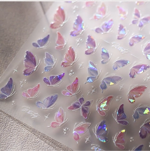 Macro view of laser holographic butterfly nail stickers with shiny metallic glitter finish