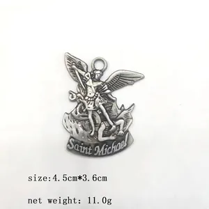 Macro view of Saint Michael metal pendant with detailed religious carving and antique finish