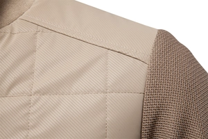 Macro shot of men jacket shoulder featuring quilted diamond pattern and knit texture