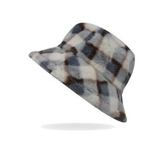 Detailed view of the plaid faux fur bucket hat featuring soft winter plush texture