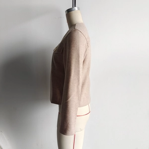 Detailed side view of beige short wool jacket fabric and flap pocket decoration