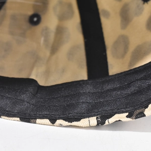Detail of leopard print baseball cap interior featuring black sweatband and neat stitching