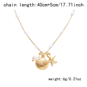 Detail of starfish and shell charms on golden necklace with pearls and size specs