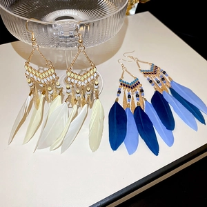 Bohemian feather drop earrings with beads and gold grid in cream and blue colors