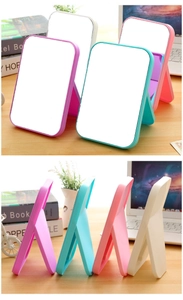 Foldable desktop makeup mirror in pastel colors with adjustable matte plastic stand