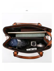 Top view of brown leather tote showing spacious interior compartments for essentials