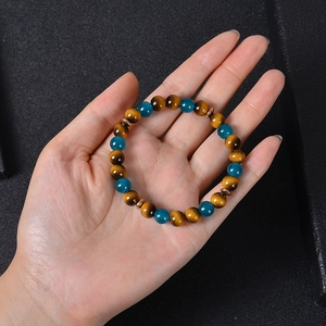 Tiger eye and blue crystal stone beaded bracelet with rose gold spacers on hand