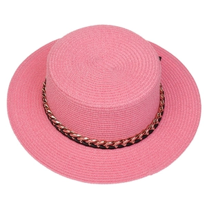 Detail of pink straw boater hat featuring a stylish gold chain and black leather band