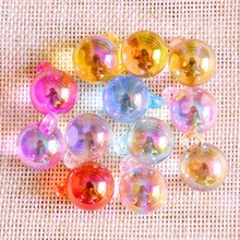 Macro shot of 16mm iridescent colorful glass ball charms with glitter and hanging loops