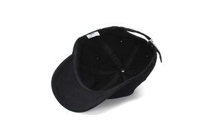 Detail of internal six-panel structure and 100% cotton wash label of black baseball cap