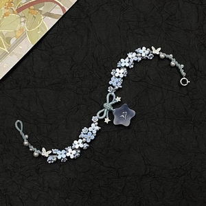 Blue bow floral charm bracelet with resin flowers and pearls on woven cord