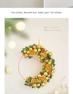 Close-up of a crescent Christmas wreath with golden flowers and ornaments on a wall