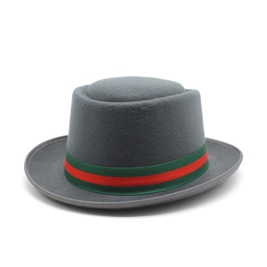 Detail of grey wool fedora hat featuring classic green and red striped ribbon band